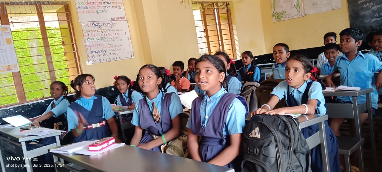 Students in blue uniforms learning in bright classroom with large windows